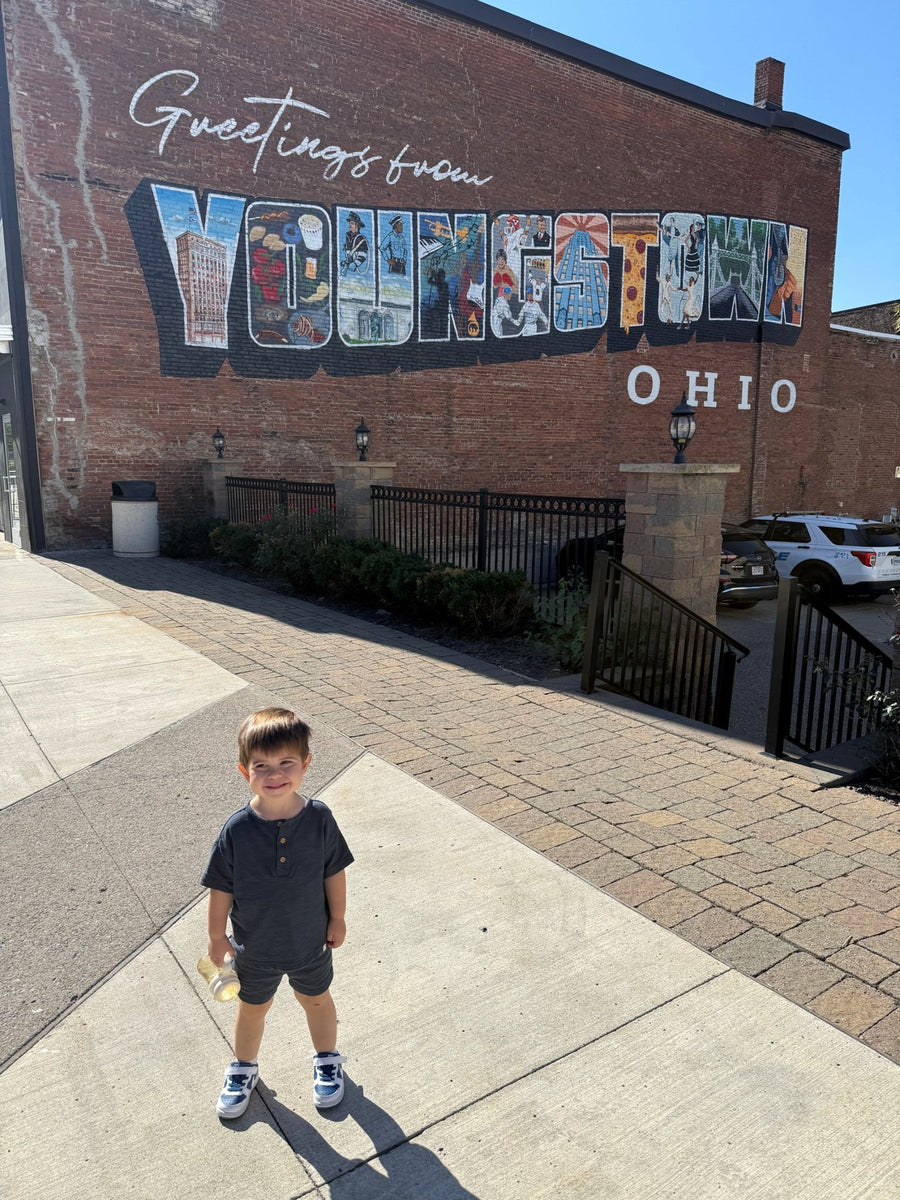 Bennett in front of the Greetings from Youngstown mural